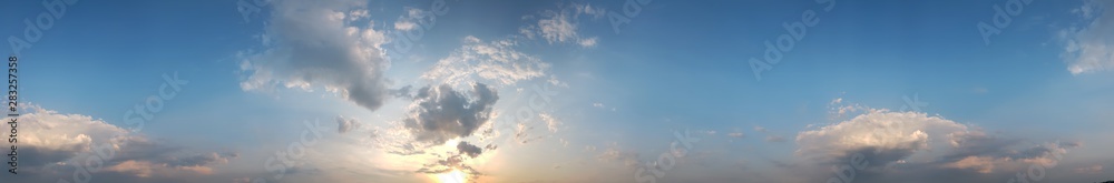 Panoramic view of cloudy sky in a sunset rays abstract background.
