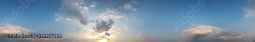 Panoramic view of cloudy sky in a sunset rays abstract background.