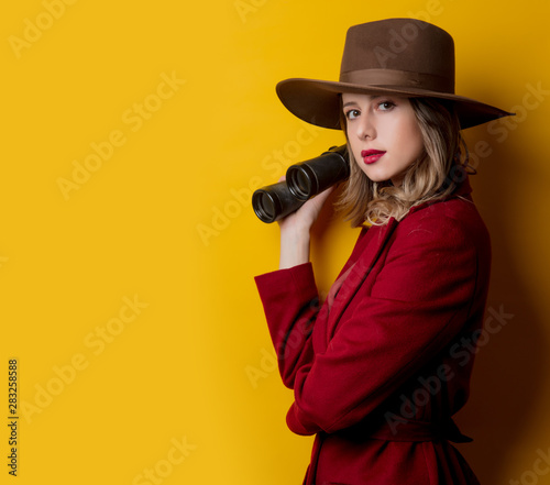 Woman in 1940s style clothes and binoculars