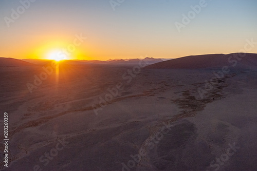 Early morning sunlight illuminating the red sand of Namibias sussusvlei