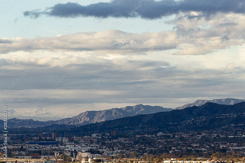 ariel view of downtown burbank, with hillside homes, san gabriel mountains