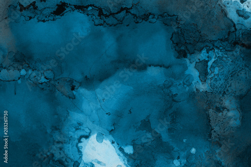 Hand painted blue alcohol ink background. Abstract delicate winter season texture. Contemporary wallpaper. 