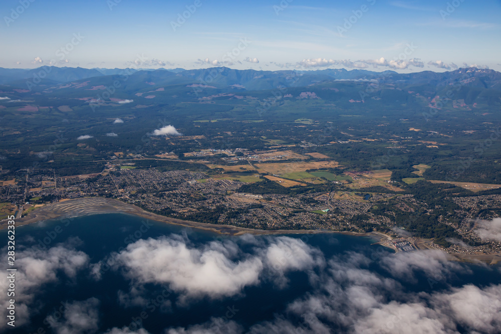 Aerial view of a small town, Parksville, on Vancouver Island during a sunny summer morning. Taken near Nanaimo, British Columbia, Canada.