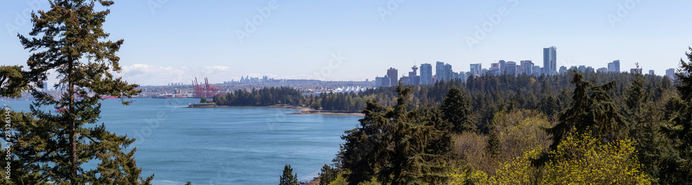 Aerial panoramic view of Stanley Park and Downtown City during a vibrant sunny day. Taken from Lions Gate Bridge, Vancouver, British Columbia, Canada.