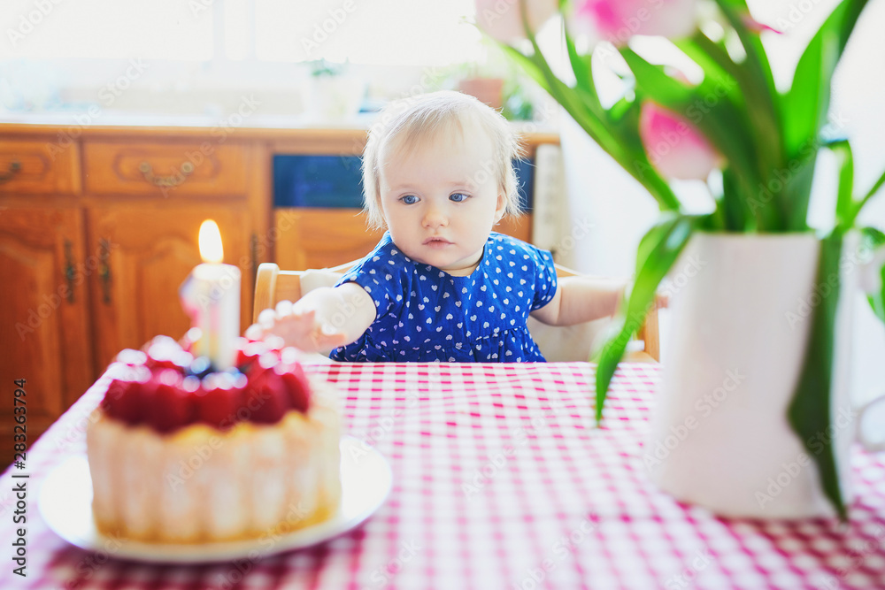 Happy baby girl in blue dress celebrating her first birthday Happy baby girl in blue dress celebrating her first birthday