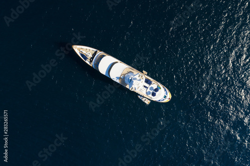 View from above, stunning aerial view of a luxury yacht sailing on a blue sea. Emerald Coast (Costa Smeralda) Sardinia, Italy.