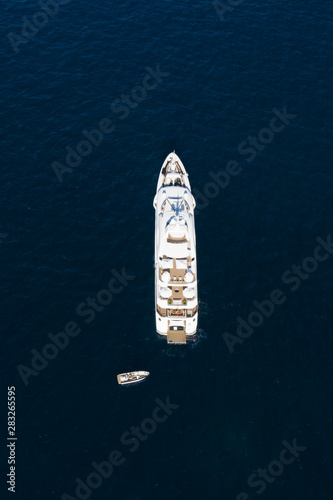View from above, stunning aerial view of a luxury yacht sailing on a blue sea. Emerald Coast (Costa Smeralda) Sardinia, Italy. © Travel Wild