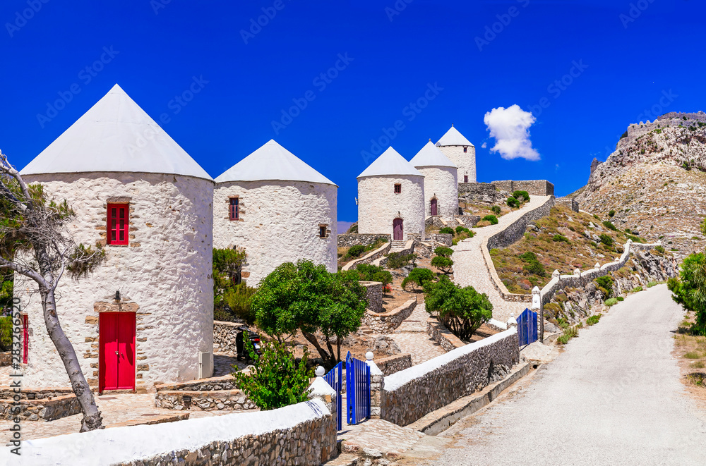 Naklejka premium Mediterranean Aesthetics of Greece: Row of Traditional White Windmills in Leros Island, Panteli Village Overlooking Aegean Sea, Iconic Dodecanese Landscape, Summer Travel Concept 4K High Resolution