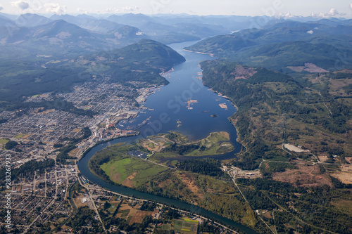 Aerial view of a small industrial town, Port Alberni, on Vancouver Island during a sunny summer morning. Located in British Columbia, Canada.