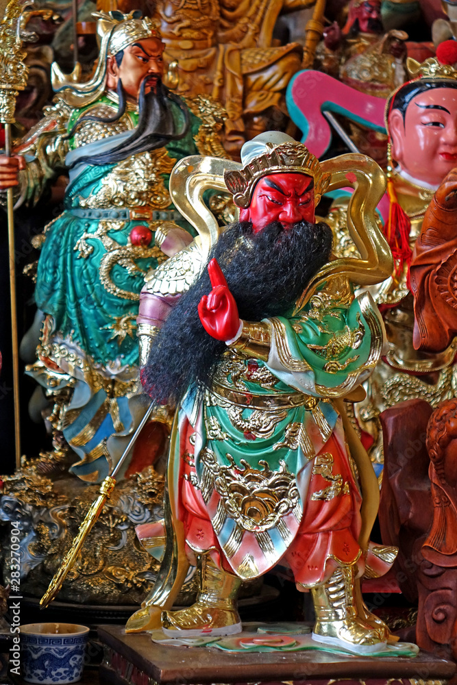 Colorful Taoist god sculpture of  Guan Yu. Guan Yu is a guardian deity, the god of war and wealth in Taoist temple. Selective focus.