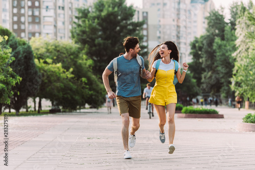 handsome man and asian woman running and looking at each other