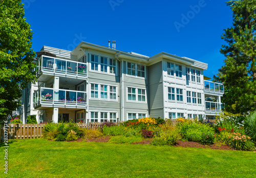 Luxury apartment building with green lawn in front