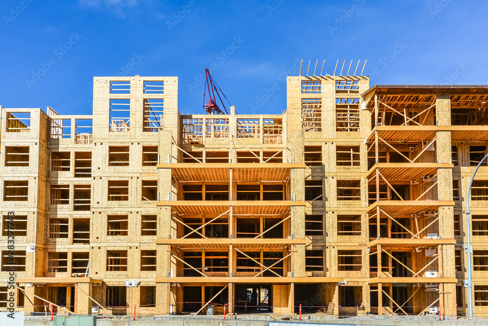 Six storey frame building under construction on concrete foundation bed. Six storey frame building under construction on concrete foundation bed.