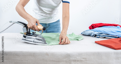 A family woman is ironing clothes at home © WR.LILI
