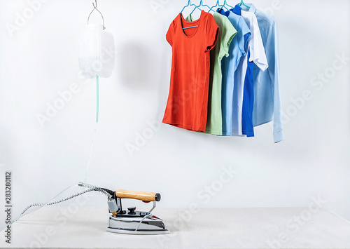 Ironing on the table and hanging ironed clothes