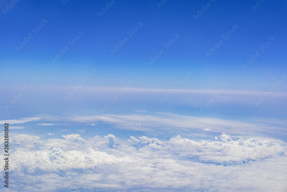 Top view on plane of Blue sky and white puffy clouds. Top view on plane of Blue sky and white puffy clouds.