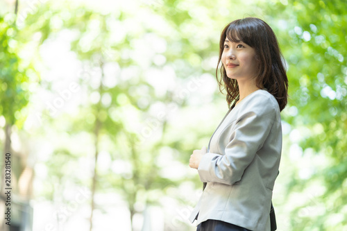 Free Download portrait of asian businesswoman walking in sidewalk - GFXLoad