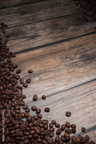 coffee beans on brown wooden background with text copy space