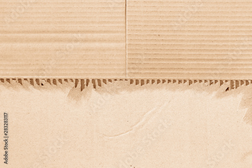 Brown corrugated or cardboard sheet texture paper torn backgroundof photo