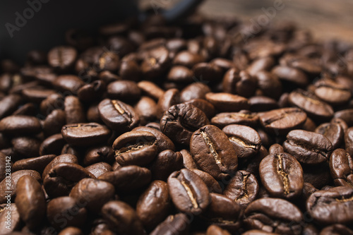 Close up coffee beans on brown wooden background