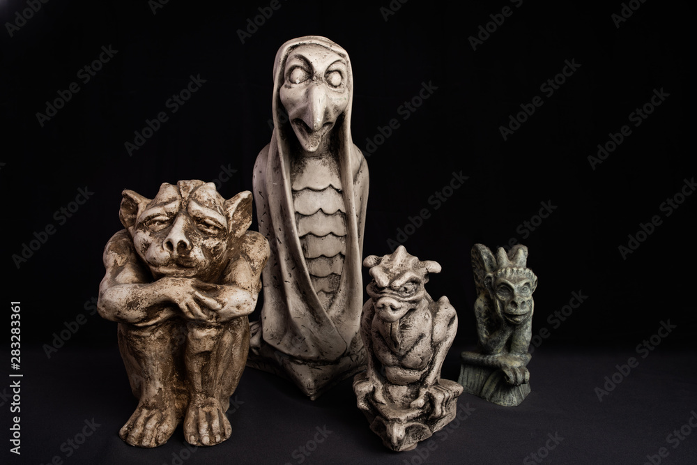 Gargoyle figurines on black and gray background. Gargoyle figurines on black and gray background.