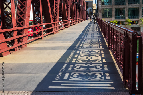 Shadows of the bridge railing design on Wells Street drawbridge in downtown Chicago Loop
