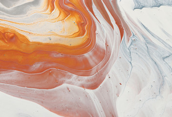 photography of abstract marbleized effect background. brown, orange, gold, gray and white creative colors. Beautiful paint