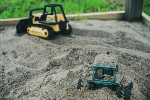 Vintage metal construction toys buried in sandbox