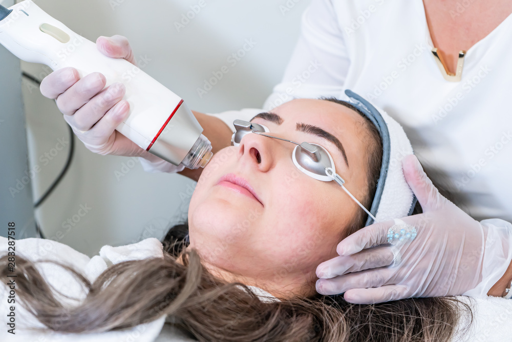 Beautician Applying Radio Frequency Microneedling Handpiece To A Woman ...