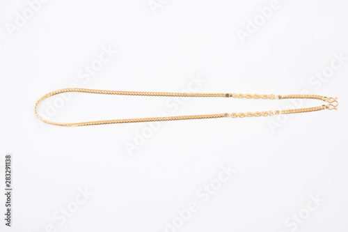Gold chain necklace isolated on white background.