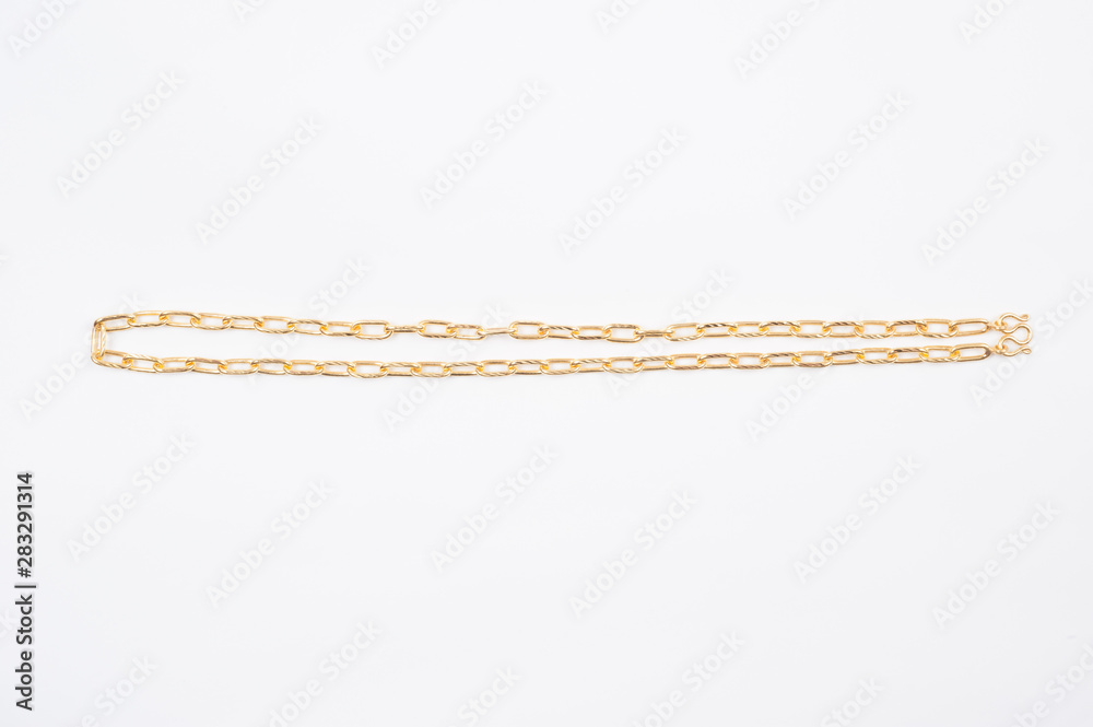 Gold chain necklace isolated on white background.