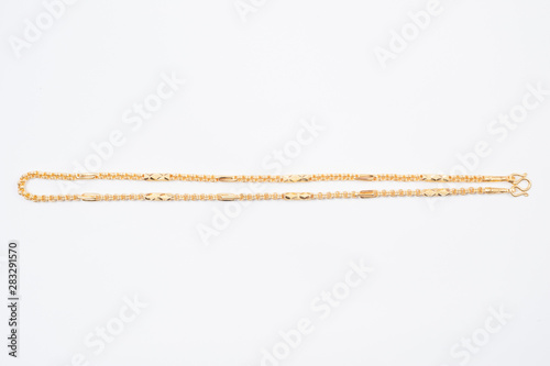 Gold chain necklace isolated on white background.