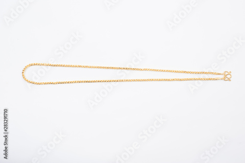 Gold chain necklace isolated on white background.