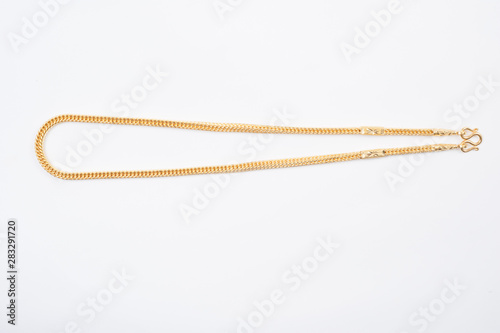 Gold chain necklace isolated on white background.