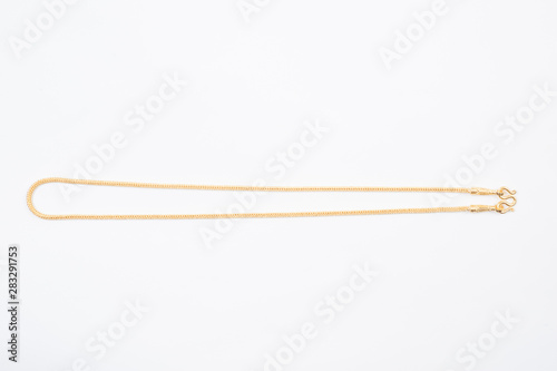 Gold chain necklace isolated on white background.