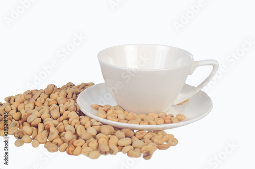 Raw coffee beans in coffee cup on open space.