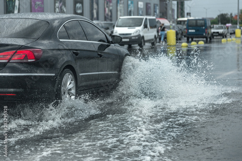 Valokuva Driving car on flooded road during flood caused by torrential rains