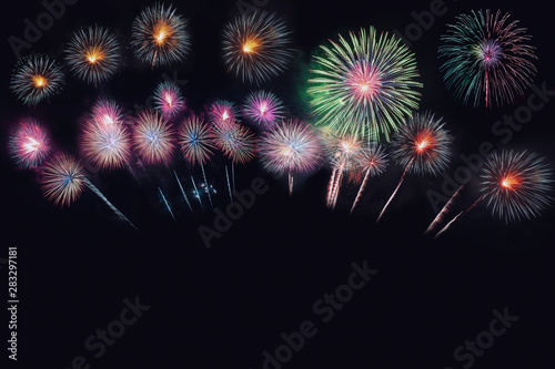 Festive beautiful colorful fireworks display on the sea beach, Amazing holiday fireworks party or any celebration event in the dark sky