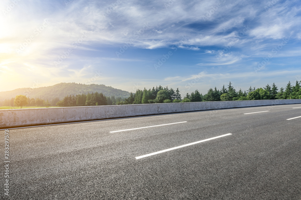 Country asphalt road and green woods nature landscape in summer Country asphalt road and green woods nature landscape in summer