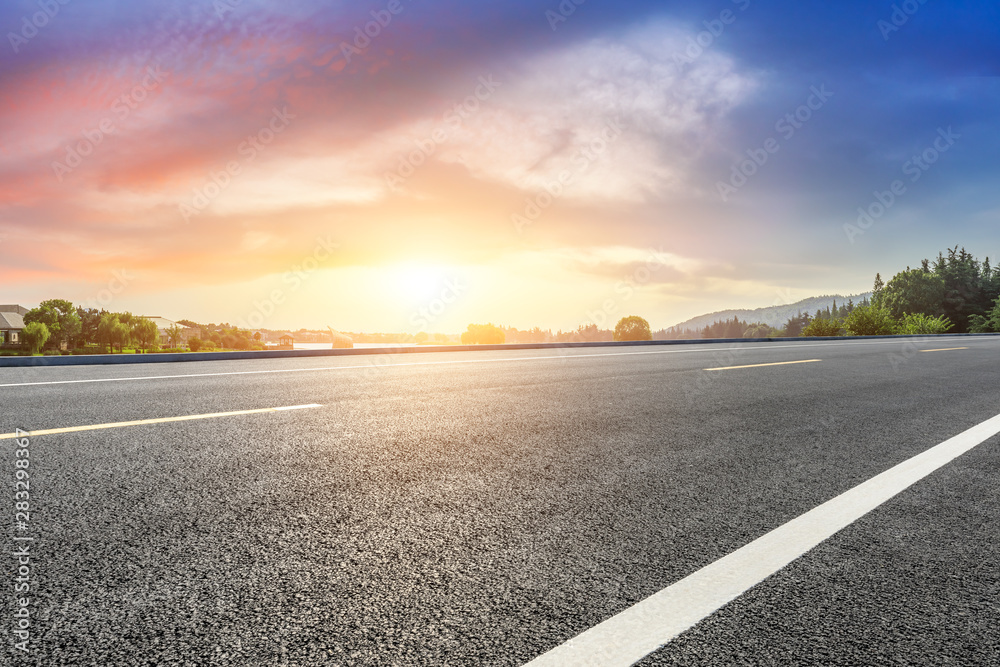 Fototapeta premium Empty asphalt road and beautiful natural scenery in city park