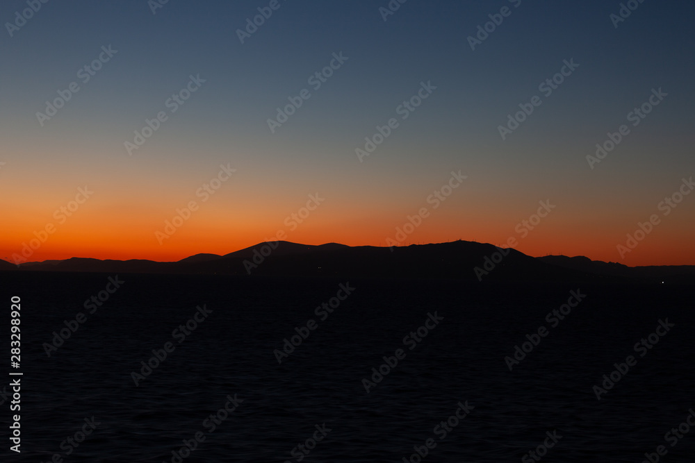 Last lights of the sunset on the islands of the Aegean sea Last lights of the sunset on the islands of the Aegean sea