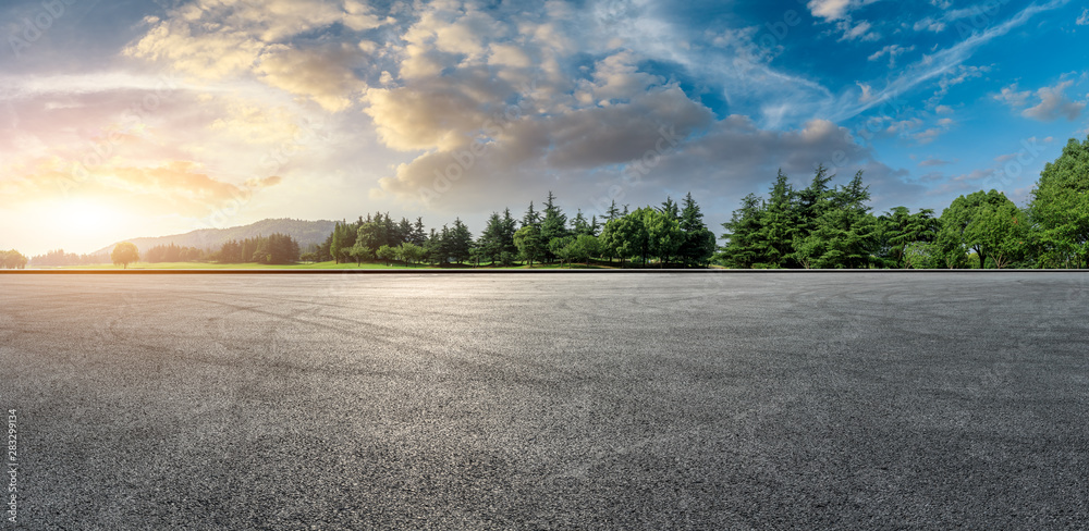 Wide race track and green woods nature landscape at sunset