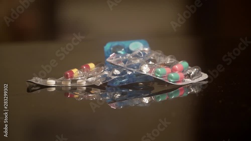 used medicine hospital tablets on a table top with cinematic painkiller photo