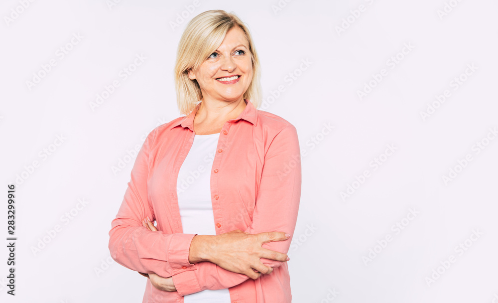 Close up portrait of happy smiling and beautiful blonde senior woman isolated in studio and posing with smile on camera Close up portrait of happy smiling and beautiful blonde senior woman isolated in studio and posing with smile on camera