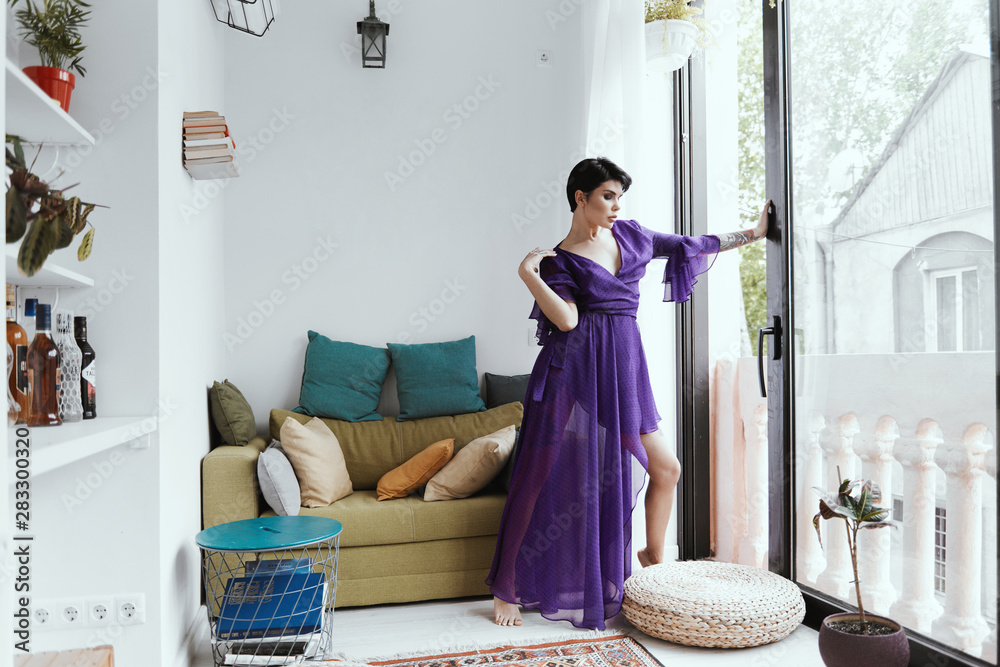 female with short haircut poses in Tbilisi loft