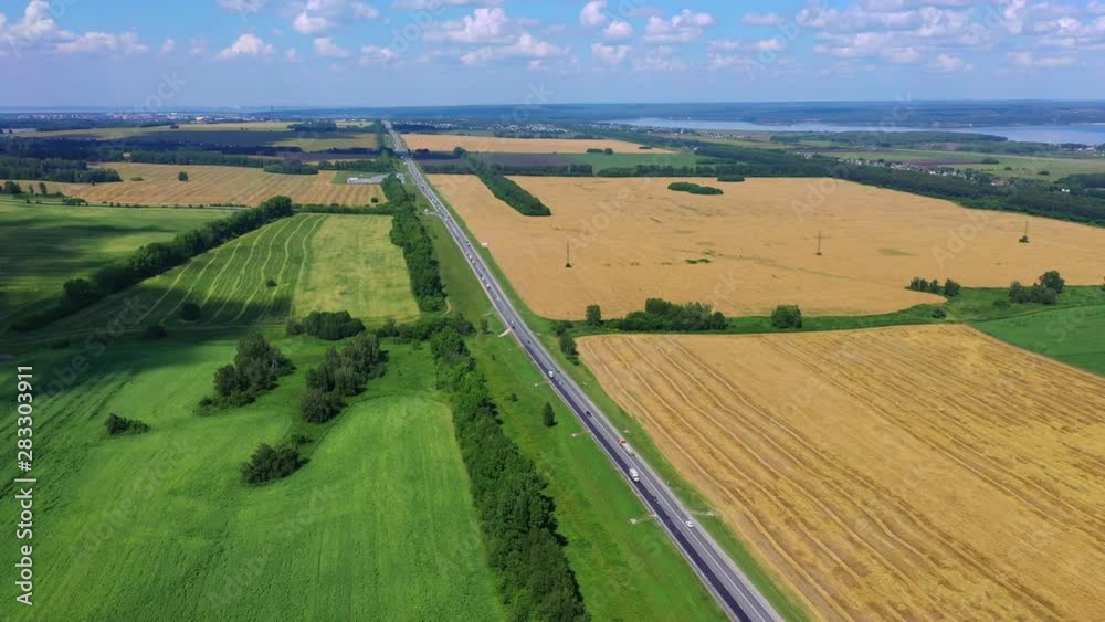 Road on countryside, Cinema 4k aerial view above a asphalt road, between yellow fields and other green fields, in Altai, Russia Road on countryside, Cinema 4k aerial view above a asphalt road, between yellow fields and other green fields, in Altai, Russia