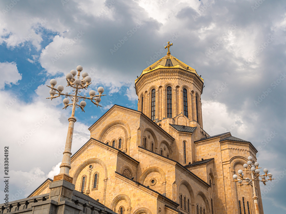 The Holy Trinity Cathedral of Tbilisi against blue sky with clouds The Holy Trinity Cathedral of Tbilisi against blue sky with clouds