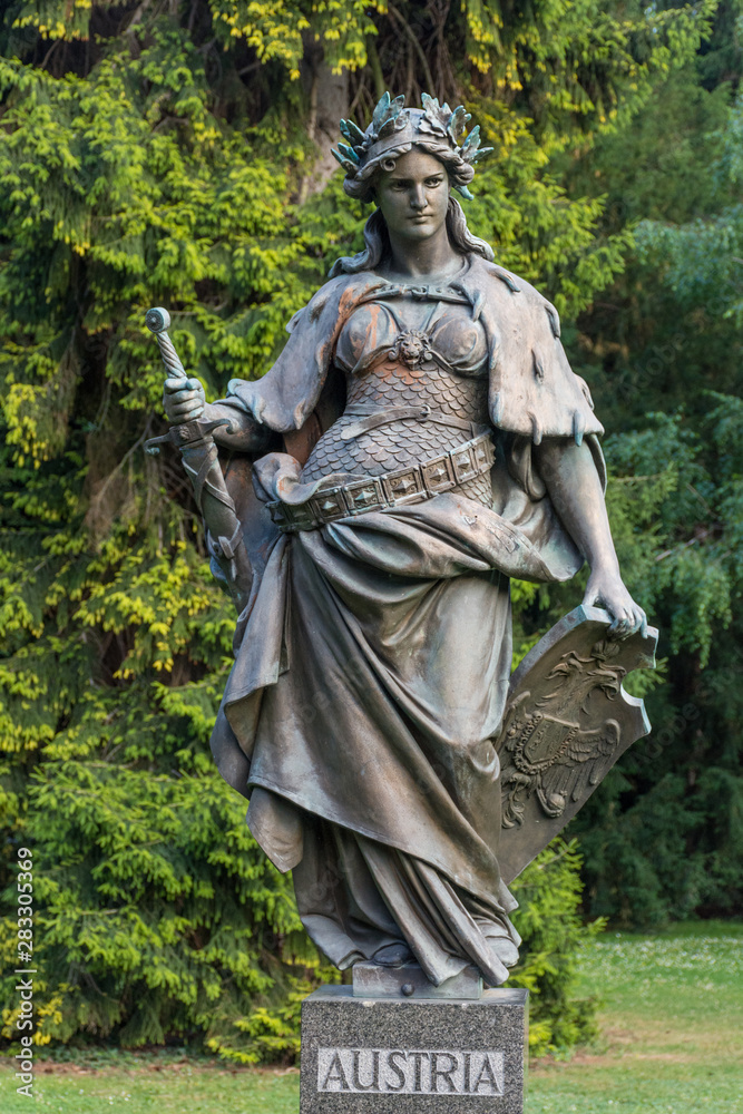 Statue representing Austria in the city park Stadtpark, a green island in the middle of the city, in Graz, Styria region, Austria.