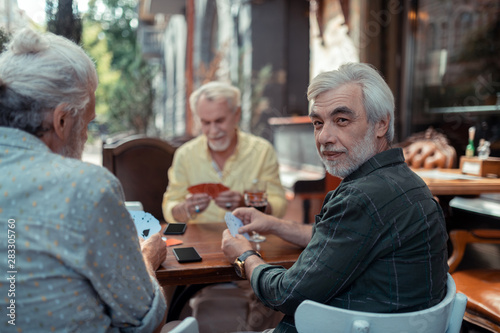 Aged men gambling sitting outside the pub