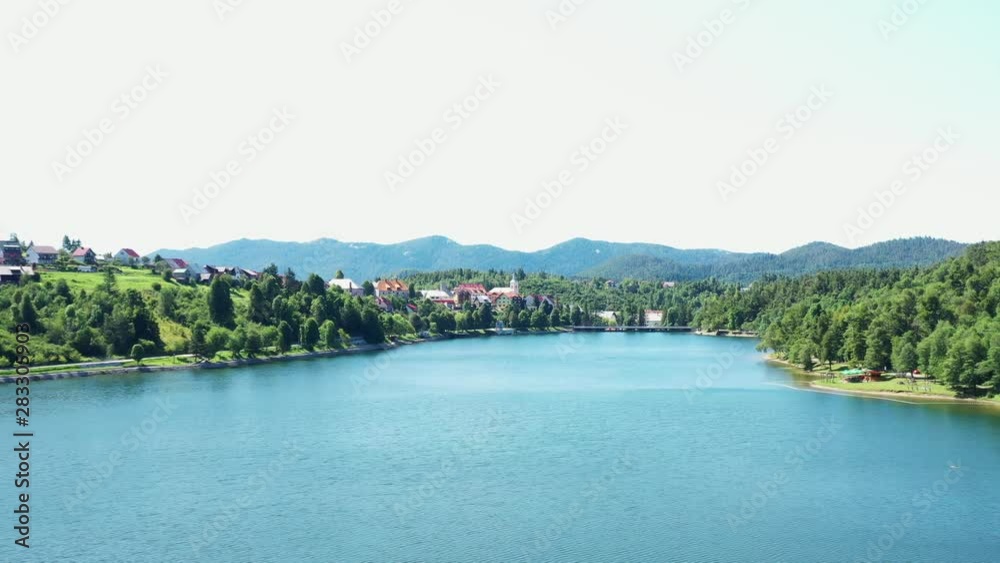 Panoramic view of town of Fuzine on beautiful Lake Bajer, Gorski kotar region, Croatia, drone panning shot Panoramic view of town of Fuzine on beautiful Lake Bajer, Gorski kotar region, Croatia, drone panning shot